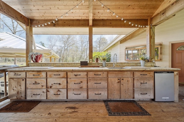 kitchen with hardwood / wood-style floors, a sink, light countertops, rail lighting, and wooden ceiling