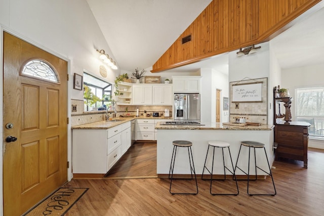 kitchen with a wealth of natural light, dark wood finished floors, and appliances with stainless steel finishes