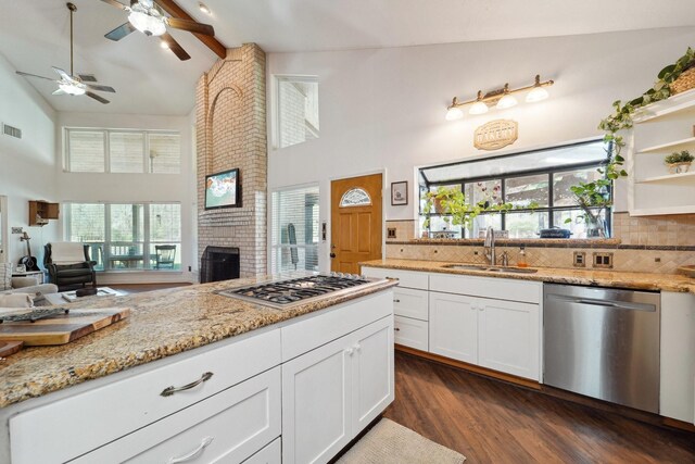 kitchen featuring a sink, ceiling fan, open floor plan, stainless steel appliances, and open shelves