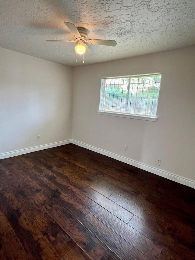 empty room featuring a textured ceiling, baseboards, a ceiling fan, and hardwood / wood-style flooring