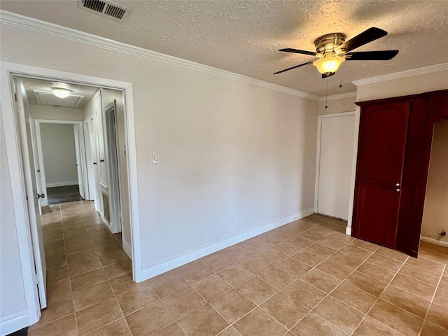 unfurnished bedroom with light tile patterned floors, baseboards, visible vents, a textured ceiling, and crown molding