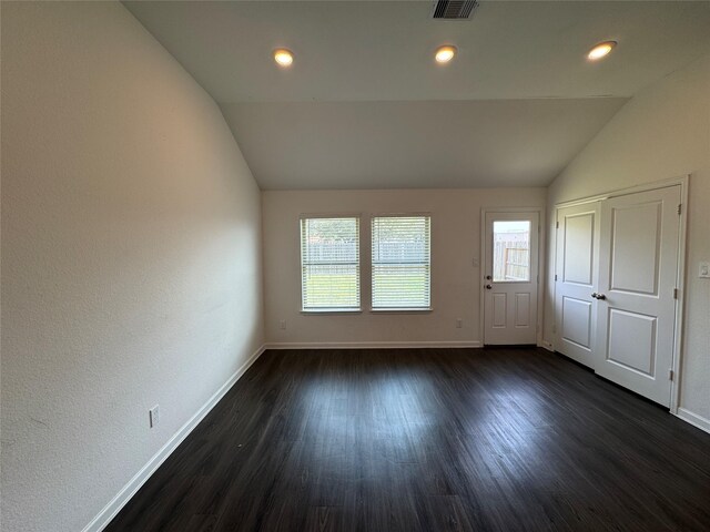 unfurnished room featuring baseboards, visible vents, recessed lighting, vaulted ceiling, and dark wood-type flooring