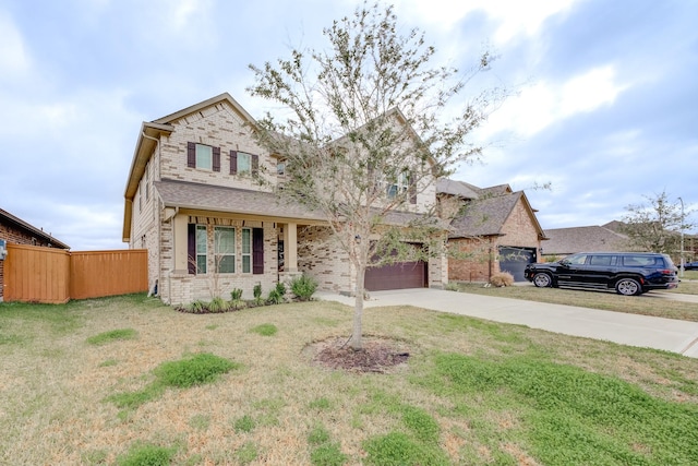 view of front of house featuring fence, driveway, an attached garage, a front lawn, and brick siding