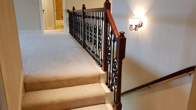 stairway with carpet flooring and baseboards