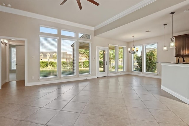 unfurnished living room featuring light tile patterned floors, ornamental molding, baseboards, a ceiling fan, and a chandelier