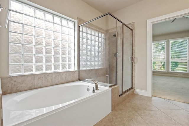 full bath featuring a garden tub, a stall shower, and tile patterned floors