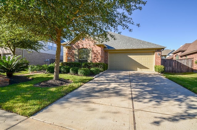 ranch-style home with brick siding, a front lawn, fence, concrete driveway, and an attached garage