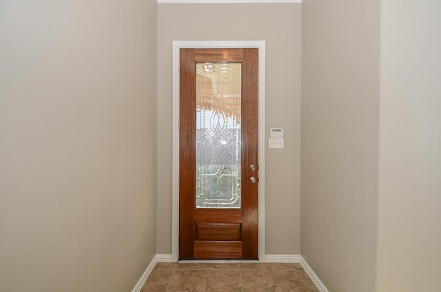 doorway to outside featuring baseboards