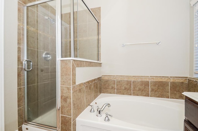 bathroom with a shower stall, vanity, and a garden tub