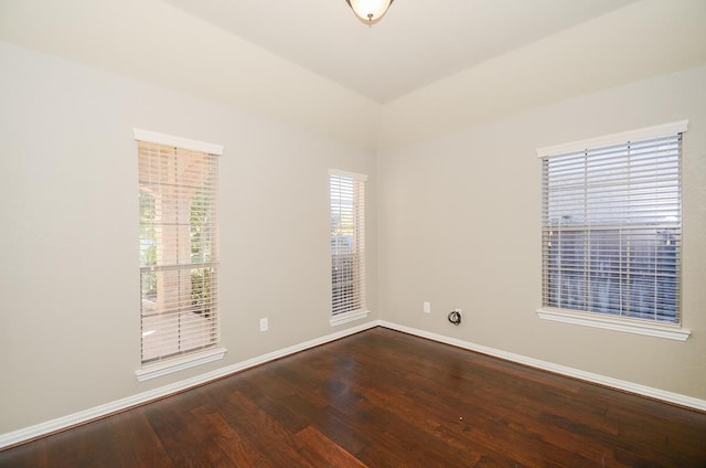 empty room featuring baseboards and wood finished floors