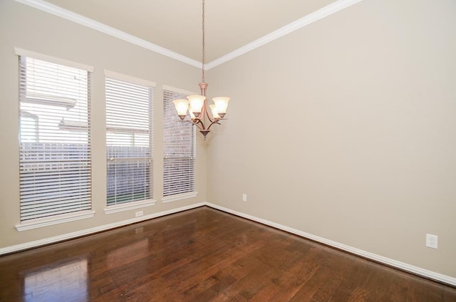 spare room featuring dark wood finished floors, baseboards, an inviting chandelier, and ornamental molding