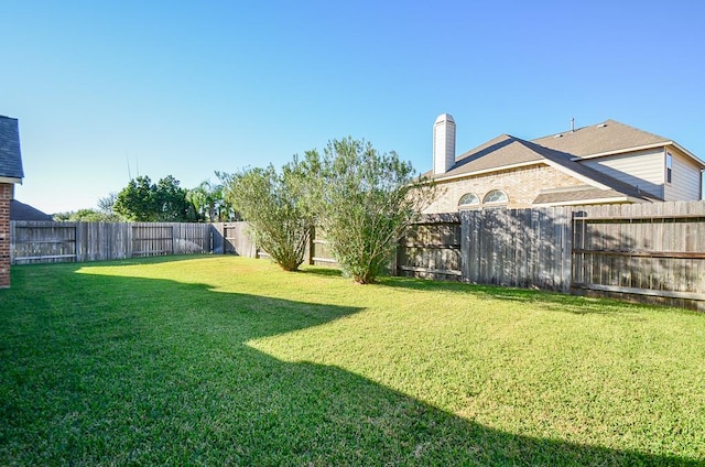 view of yard with a fenced backyard