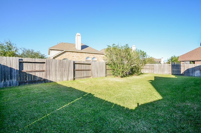 view of yard featuring a fenced backyard