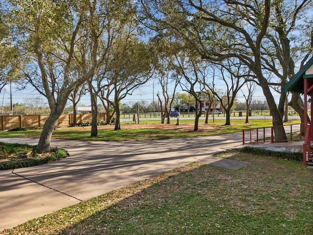 surrounding community featuring a lawn and fence