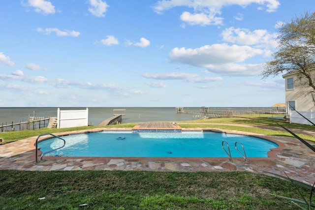 view of swimming pool featuring a yard, fence, a fenced in pool, and a water view