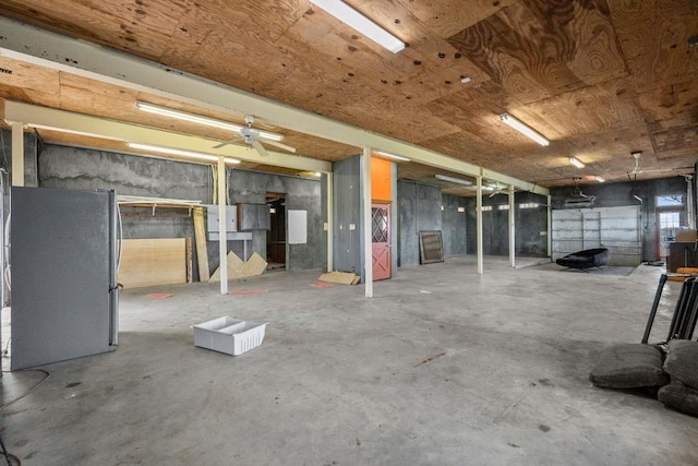 garage featuring wood ceiling and freestanding refrigerator