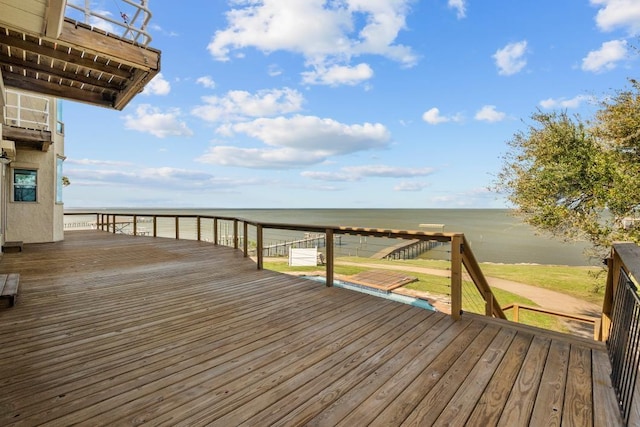 wooden terrace featuring a water view