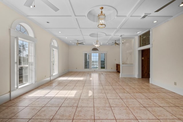 unfurnished living room with a wealth of natural light, light tile patterned flooring, ceiling fan with notable chandelier, and coffered ceiling