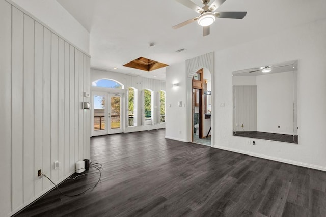 unfurnished living room with visible vents, baseboards, dark wood-type flooring, and ceiling fan