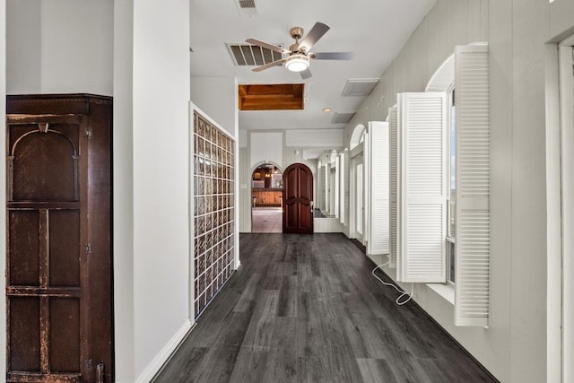 corridor with dark wood-style floors and visible vents