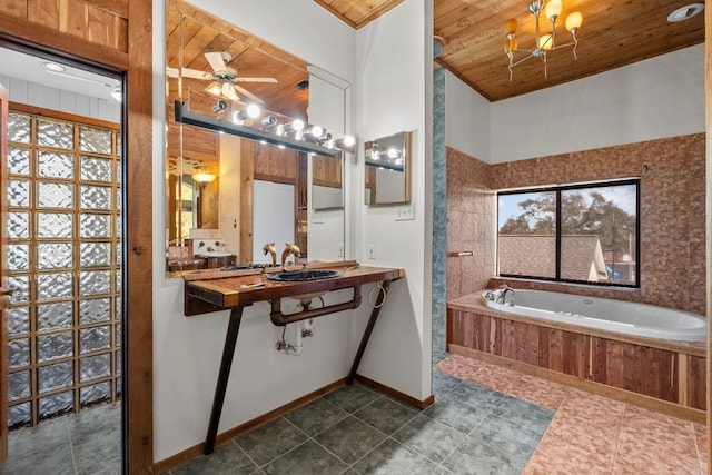 bathroom featuring baseboards, wood ceiling, a garden tub, tiled shower, and a ceiling fan