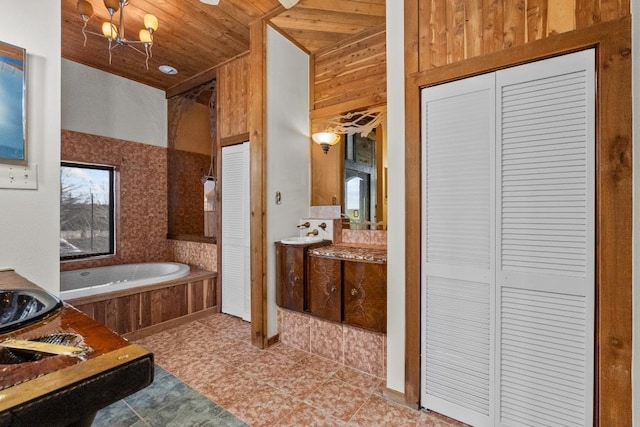 bathroom featuring vanity, wooden ceiling, a bath, and a closet