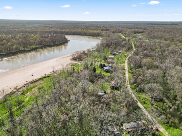 birds eye view of property with a water view and a wooded view