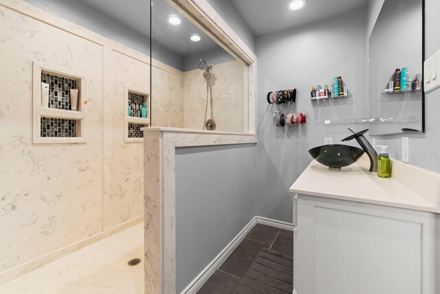 bathroom with vanity, tile patterned floors, recessed lighting, and tiled shower