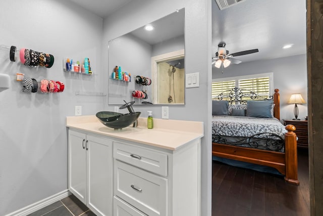 bathroom featuring visible vents, wood finished floors, baseboards, ceiling fan, and vanity