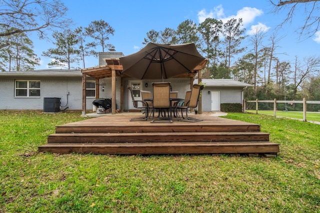 rear view of house featuring fence, a yard, central AC, a chimney, and a deck