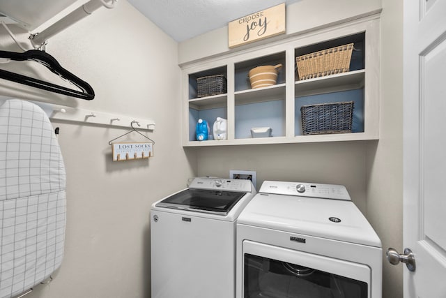 laundry room with laundry area, independent washer and dryer, and a textured ceiling