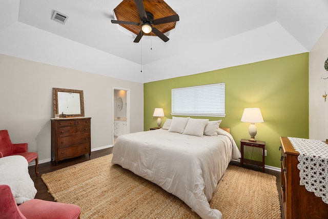 bedroom featuring baseboards, a raised ceiling, visible vents, and wood finished floors