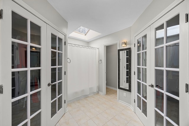 interior space with a skylight and french doors