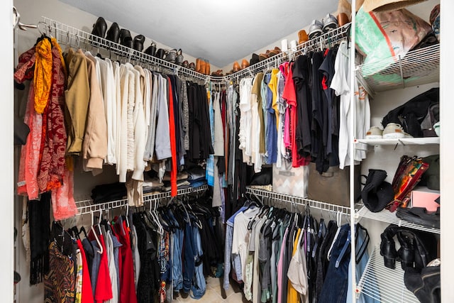 walk in closet with tile patterned floors