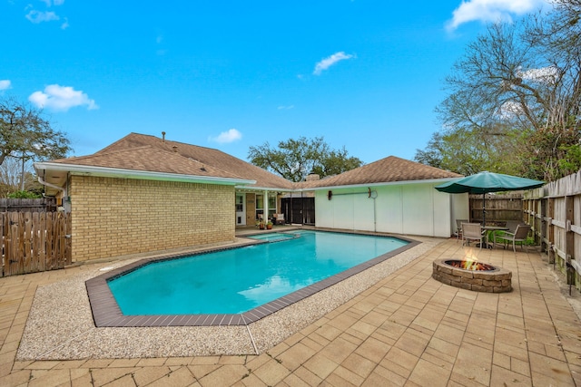 view of pool with a fenced backyard, a fenced in pool, an outdoor fire pit, and a patio