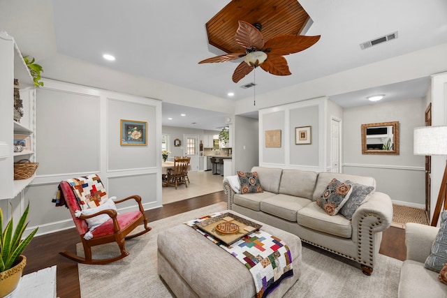 living area featuring wood finished floors, recessed lighting, a ceiling fan, and visible vents