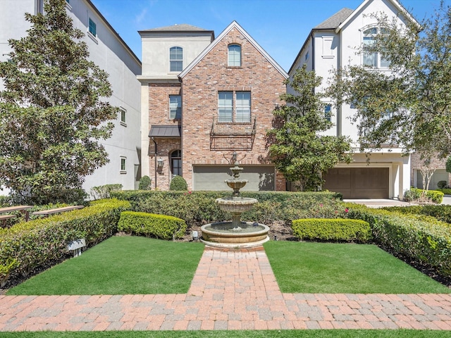 traditional-style home featuring brick siding, stucco siding, and a front yard