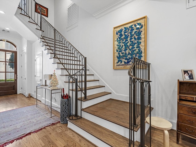 stairs featuring crown molding, recessed lighting, wood finished floors, and baseboards