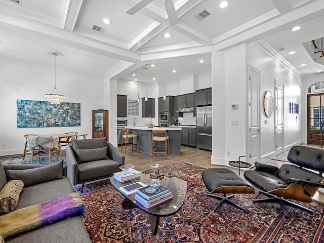 living area featuring beam ceiling, visible vents, and coffered ceiling