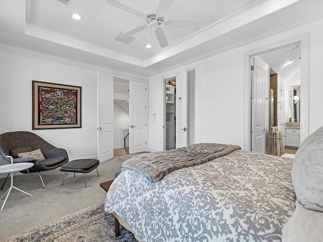 bedroom featuring a raised ceiling, crown molding, and carpet floors