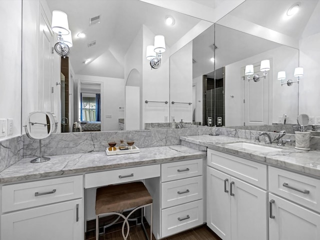 bathroom featuring visible vents, lofted ceiling, ensuite bath, and vanity