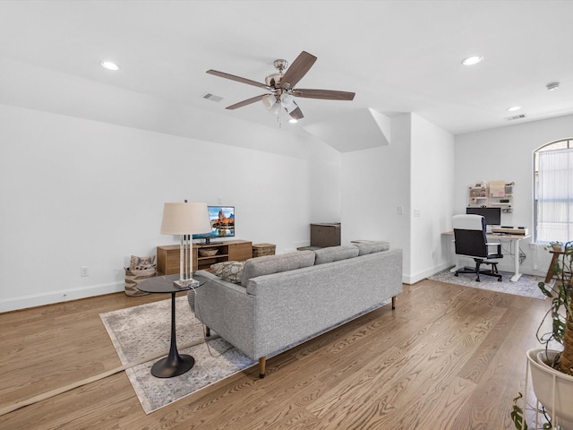 living area with visible vents, wood finished floors, and a ceiling fan