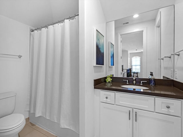 bathroom featuring vanity, visible vents, shower / bath combo with shower curtain, tile patterned floors, and toilet