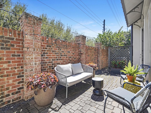 view of patio featuring outdoor lounge area and a fenced backyard