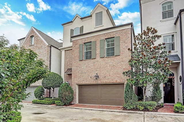 view of front of home featuring brick siding and driveway