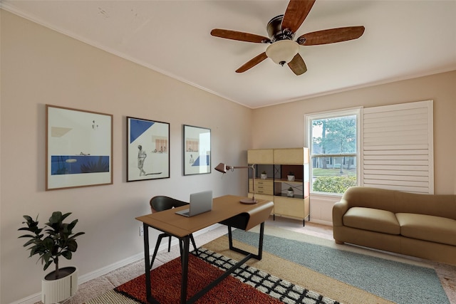 office with crown molding, light carpet, baseboards, and ceiling fan