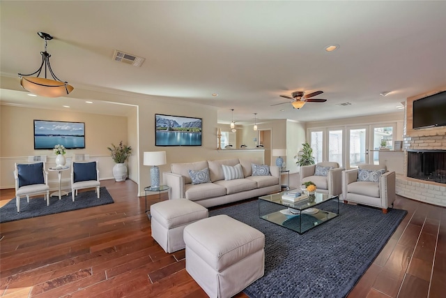 living area with visible vents, a brick fireplace, ceiling fan, recessed lighting, and wood finished floors