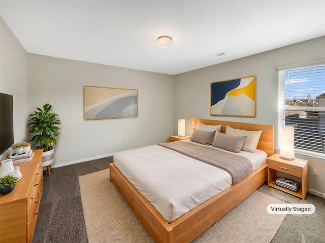 carpeted bedroom featuring visible vents and baseboards