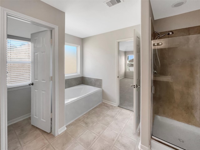 full bathroom featuring visible vents, plenty of natural light, and a shower stall