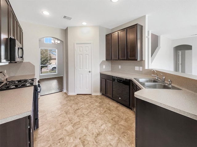 kitchen featuring black appliances, a sink, arched walkways, dark brown cabinetry, and light countertops